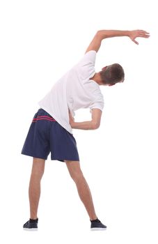 in full growth.smiling man performs morning exercises .isolated on white background