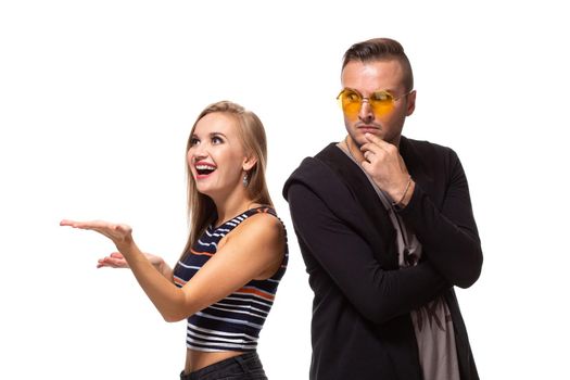 Couple watching look at something and have different emotions concept. Studio shot on white background. Copy space