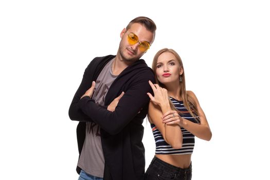 Funny young couple posing in studio. Isolated on white background. Studio shot