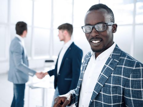 close up.young businessman standing in the office.people and technology