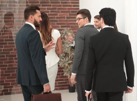 rear view.a group of business people standing in the lobby of the business center.business concept