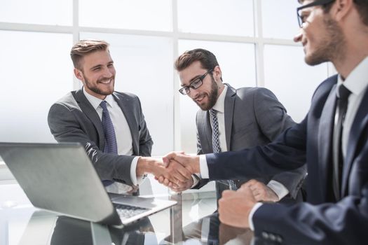 handshake employees at the Desk.the concept of cooperation