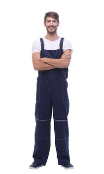 in full growth. smiling man in blue overalls. isolated on white background