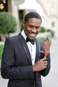 Afro american happy handsome man wearing suit and smiling. Concept of black businessman.