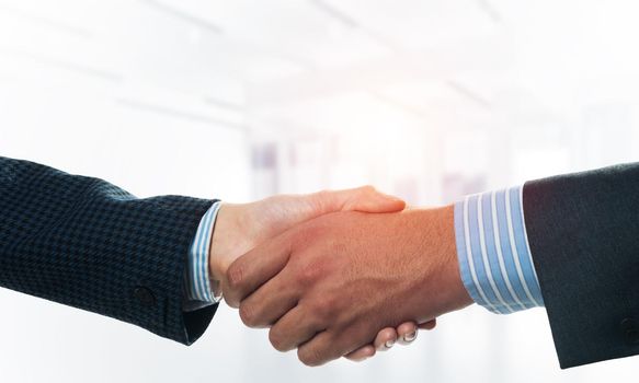 A close-up of a handshake. Making a deal between two businessmen