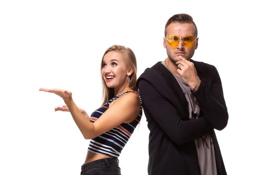 Couple watching look at something and have different emotions concept. Studio shot on white background. Copy space