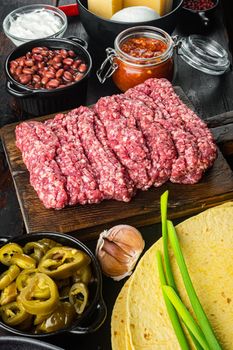 Ingredients for mexican quesadilla with salsa sauce, on old dark wooden table background