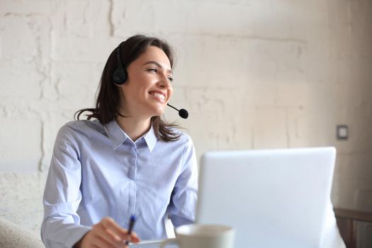 Freelance operator talking with headsets and consulting clients from home office