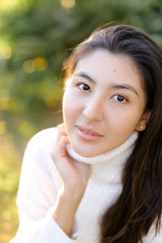 Portrait of korean woman sitting outdoors. Concept of asian female person and beauty.