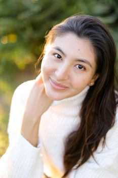 Portrait of chinese woman sitting outdoors. Concept of asian female person and beauty.