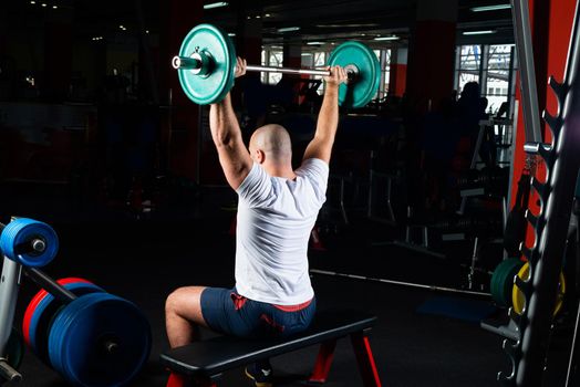 Man in the gym lifts the barbell. bodybuilding and healthy lifestyle