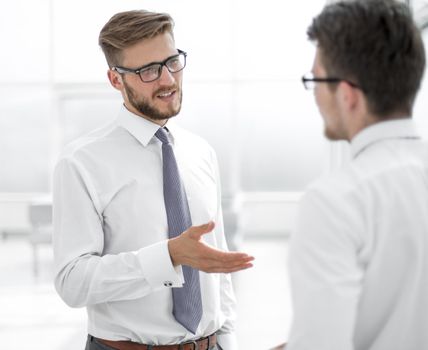 close up. employees discuss their ideas standing in the office.business concept