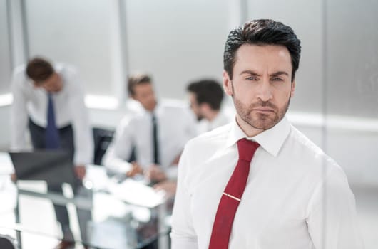 close up.serious businessman standing in the office.photo with copy space