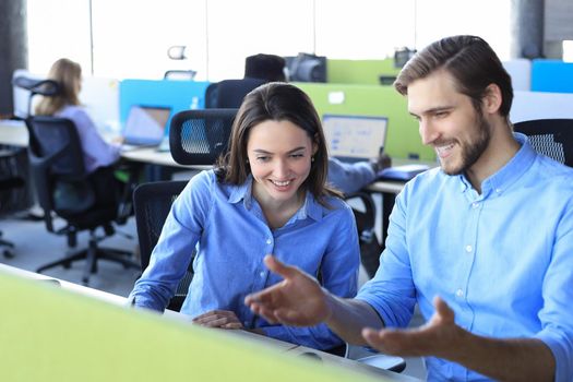 Two collegues discussing documents and other working moments in office