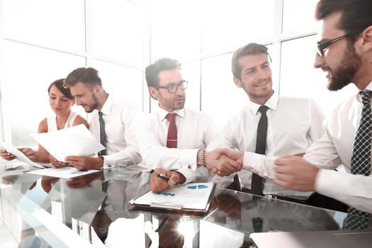 handshake colleagues at a working meeting.business concept