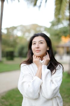 Portrait of asian girl walking outdoors. Concept of beauty and nature.