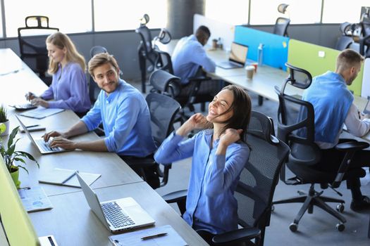 Excited businesswoman looking at laptop celebrating online success sitting in office. Woman reading good news in e-mail.