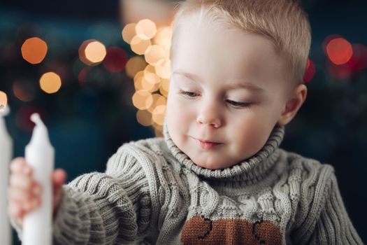 Picture of cute little male child with a candle at home