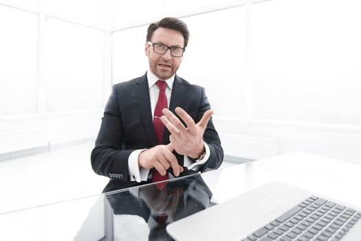 Businessman counts on his fingers, sitting at his Desk. business concept