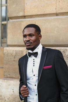 Afro american man wearing suit and standing outside. Concept of black businessman.