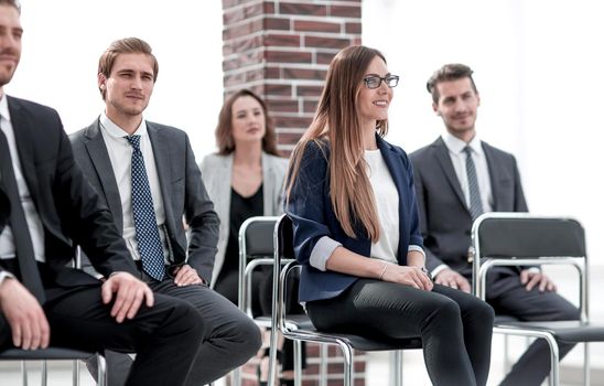 Businesswoman asking questions during seminar