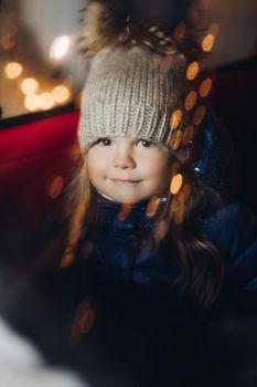 Picture of cute little girl in a warm clother and smiles