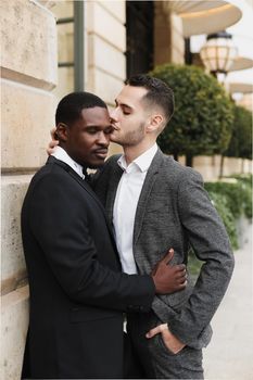 Afro american gay hugging european man outdoors. Concept of lgbt and same sex couple.