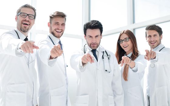 group of doctors pointing their finger at you.the concept of health
