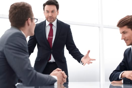 businessman talking with employees at a working meeting. business problem