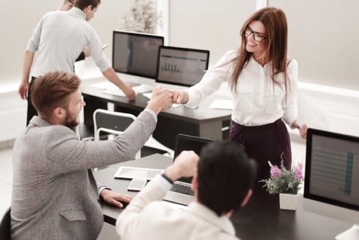 young employees with a gesture of showing their success .the concept of teamwork