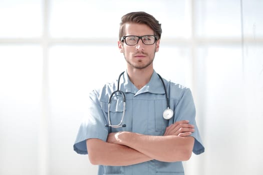 confident surgeon man in blue uniform with a stethoscope around his neck.