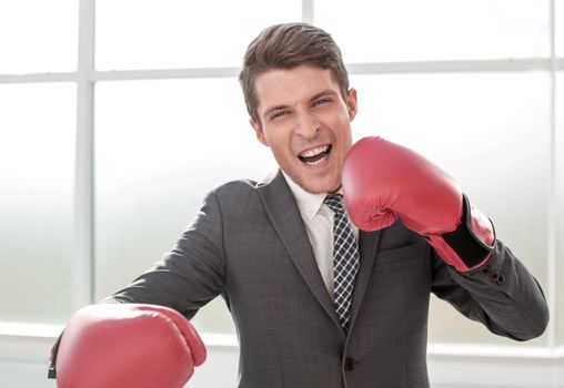 happy businessman in Boxing gloves.concept of competitiveness