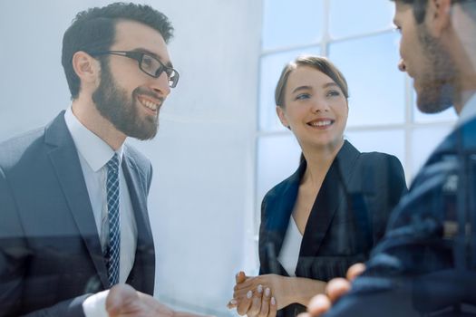 close up.employees discussing new ideas standing in the office.photo with copy space