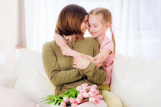 Pretty child hugging mother with love, Mothers day, 12th of May