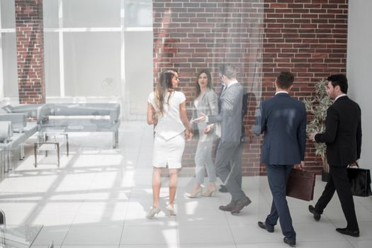 employees pass through the hall of the modern office. business background