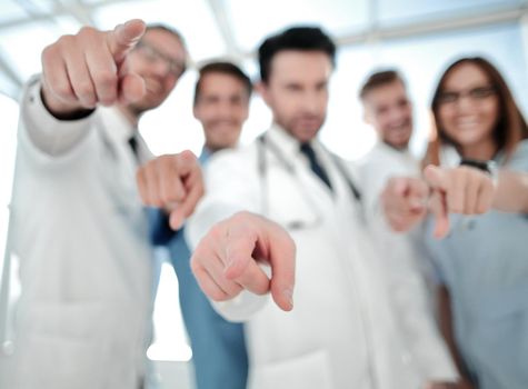 Nurse and doctors choose something empty with their finger in the camera