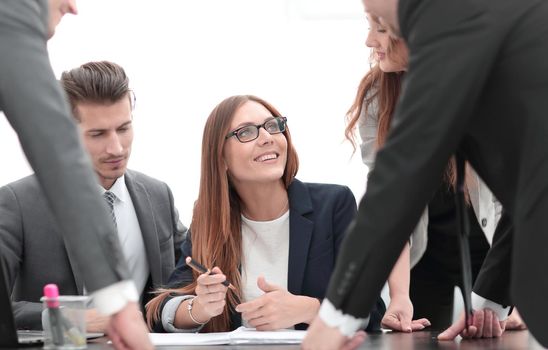 men and women working with documents in the office