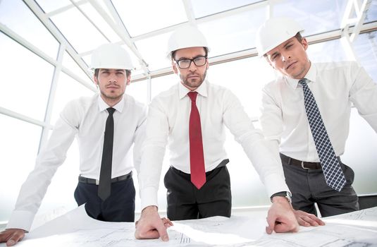 group of architects standing in front of the Desk. the concept of professionalism