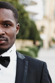 Afro american man wearing suit and standing outside. Concept of black businessman.