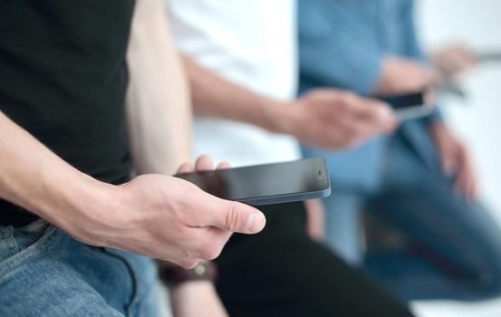 close up.a group of young people with smartphones.people and technology