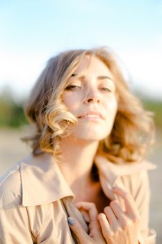 Portrait of woman wearing coat and standing outside. Concept of beauty without makeup, female model.