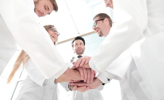 bottom view. close up of a doctors folded their hands together.concept of teamwork