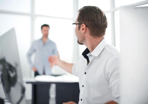 businessman talking with a colleague in the workplace.business background