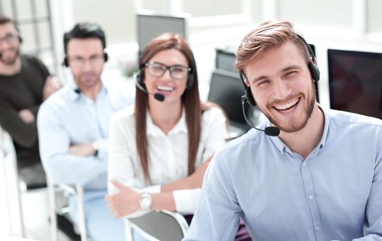 rear view.employees of the call center looking at the camera.business concept