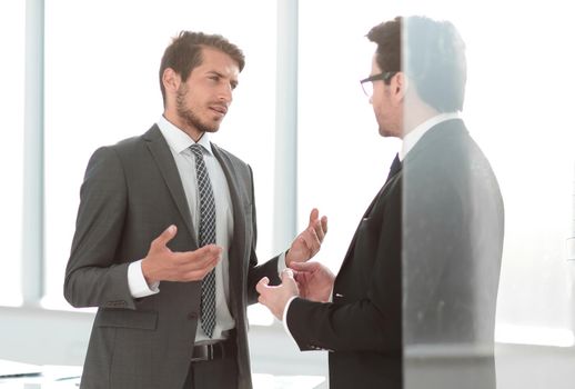 boss and Manager discuss standing in the office.photo with text space