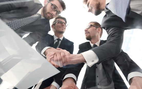 bottom view.businessmen shaking hands at the negotiating table.business concept