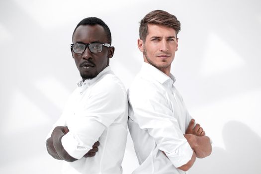 two young business partners standing back to back.concept of partnership