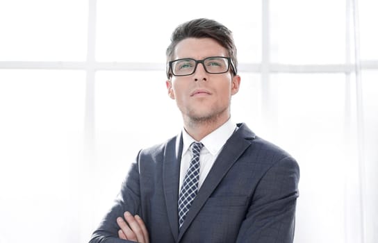 close up.young businessman standing near the window. business people