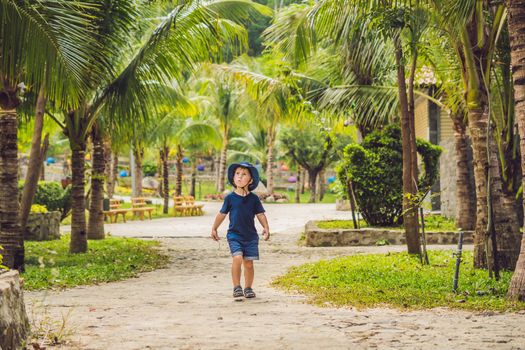 Boy traveler walks in the park in Asia.