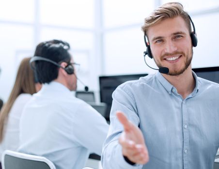 call operator stretching out his hand for a handshake .photo with copy space